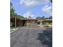 House exterior with a carport and landscaped front yard at 906 Tropical Dr, Bradenton, FL 34208