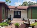 Front entry of home with double doors and brick steps at 906 Tropical Dr, Bradenton, FL 34208