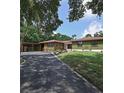House exterior showcasing a green house with a paved driveway at 906 Tropical Dr, Bradenton, FL 34208