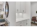 White shaker cabinets and a quartz countertop in butlers pantry at 4625 Royal Dornoch Cir, Bradenton, FL 34211