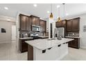 Modern kitchen with stainless steel appliances and a large island at 8600 Rain Song Rd, Sarasota, FL 34238