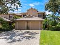 Tan two-story house with a two-car garage at 5268 Heron Way # 204, Sarasota, FL 34231