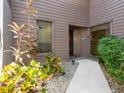 Side view showing a walkway and landscaping leading to the entrance of the home at 4068 Wilshire E Cir # 145, Sarasota, FL 34238