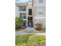 Exterior view of an apartment building with stairs and landscaping at 5122 Northridge Rd # 107, Sarasota, FL 34238