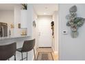Bright and airy entryway with tile flooring and modern wall decor at 5122 Northridge Rd # 107, Sarasota, FL 34238
