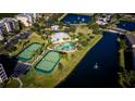 Community features tennis courts, pool, and a serene lake setting at 9967 Key Haven Rd # 19, Seminole, FL 33777