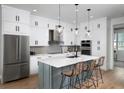 Modern kitchen with white cabinets, island, and stainless steel appliances at 9955 Key Haven Rd, Seminole, FL 33777