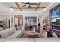 Open-concept living area showcasing a stylish wet bar with glass cabinets and modern furnishings and fireplace at 13212 Deep Blue Pl, Lakewood Ranch, FL 34211