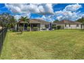 Large backyard with spacious lawn, palm trees and a screened patio at 7407 64Th E St, Palmetto, FL 34221