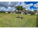 Large backyard with spacious lawn, palm trees and a screened patio at 7407 64Th E St, Palmetto, FL 34221