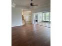 Spacious living room with hardwood floors, access to sunroom, and high ceilings at 10228 Silverado Cir, Lakewood Ranch, FL 34202