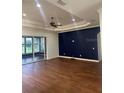 Living room with hardwood floors, high ceilings, and an accent wall at 10228 Silverado Cir, Lakewood Ranch, FL 34202