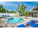 Relaxing backyard oasis with a pool, spa, and patio area at 2186 Sunnyside Pl, Sarasota, FL 34239