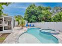 Inviting kidney-shaped pool with a spa and surrounding patio at 2186 Sunnyside Pl, Sarasota, FL 34239