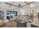 Open concept living room with kitchen and sliding glass doors at 13212 Deep Blue Pl, Lakewood Ranch, FL 34211