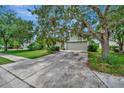 One-story home with a two-car garage and large oak tree in front at 6122 44Th E Ct, Bradenton, FL 34203