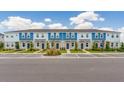 A long row of townhomes with sidewalks and parking in front, ideal for community living at 16647 San Nicola Pl, Lakewood Ranch, FL 34211