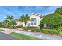 Home's exterior view with landscaping and palm trees at 7823 33Rd E St # 20, Sarasota, FL 34243