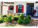 Landscaped area with red shutters and stone accents near home entrance at 3711 76Th E St, Palmetto, FL 34221