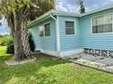 Side view of a light blue manufactured home at 1806 Brook Field Ter, Sarasota, FL 34234