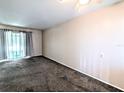 Spacious living room with gray carpet and sliding doors at 1504 Pleasant Rd # G1, Bradenton, FL 34207