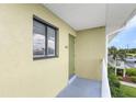 Exterior view of condo building with green door at 25225 Rampart Blvd # 2206, Punta Gorda, FL 33983