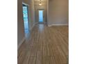 Bright and spacious entryway with wood-look tile flooring at 2620 Averland Loop, North Port, FL 34287