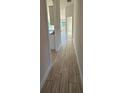 Light and bright hallway with tile flooring leading to other rooms at 2624 Averland Loop, North Port, FL 34287