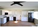 Modern kitchen with white cabinets and black appliances at 2708 Starlite Ln, Port Charlotte, FL 33952