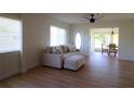 Living room with light beige sectional sofa and wood floors at 2708 Starlite Ln, Port Charlotte, FL 33952