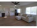 Living room with light beige sectional sofa and kitchen view at 2708 Starlite Ln, Port Charlotte, FL 33952