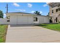 Front view of a white single-story house with a driveway and lawn at 1160 Morningside Pl, Sarasota, FL 34236