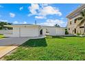White single story house with arched entryway and attached garage at 1160 Morningside Pl, Sarasota, FL 34236