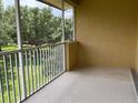Relaxing screened lanai with a peaceful view of mature trees at 6414 Moorings Point Cir # 201, Lakewood Ranch, FL 34202