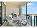 Screened balcony with table and chairs, offering a lake view at 7612 Lake Vista Ct # 405, Lakewood Ranch, FL 34202