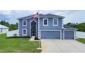 Two-story house with a two-car garage and landscaped lawn at 14312 Barbarossa Ln, Port Charlotte, FL 33981