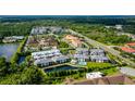 Aerial view of community with lake and pool at 5707 N Honore Ave # 621, Sarasota, FL 34243