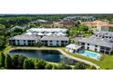 Aerial view of community with lake and pool at 5707 N Honore Ave # 621, Sarasota, FL 34243