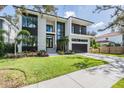 Modern two-story home with a two-car garage and landscaped yard at 214 S Renellie Dr, Tampa, FL 33609