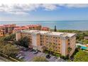 Oceanfront condo building with parking and a pool at 8630 Midnight Pass Rd # 103A, Sarasota, FL 34242