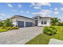 Modern house exterior with three-car garage and landscaping at 4952 Surfside Cir, Bradenton, FL 34211