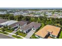 Aerial view of a luxury community with houses and a lake at 4952 Surfside Cir, Bradenton, FL 34211