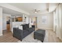 Living room with dark gray sofa, ottoman, and view of kitchen at 1050 Villagio Cir # 206, Sarasota, FL 34237