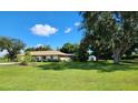 House with large backyard, mature trees, and a detached shed at 2817 Norwood Ln, Venice, FL 34292