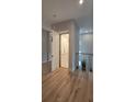 Interior view featuring an elevator, hardwood floors, and a glass railing at 3464 Camino Real, Sarasota, FL 34239