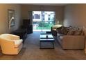 Living room with sliding glass doors and seating area at 3271 Beneva Rd # 204, Sarasota, FL 34232