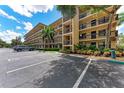 Condo building exterior with parking and landscaping at 515 30Th W Ave # H201, Bradenton, FL 34205