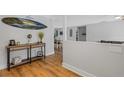 Bright and airy entryway with hardwood floors and a console table at 891 Faulkwood Ct, Sarasota, FL 34232