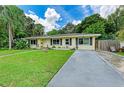 House with a spacious front yard, driveway and beautiful landscaping at 1410 21St W St, Bradenton, FL 34205