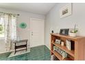 Bright and airy entryway with tiled floor, storage shelving, and entry door at 1410 21St W St, Bradenton, FL 34205